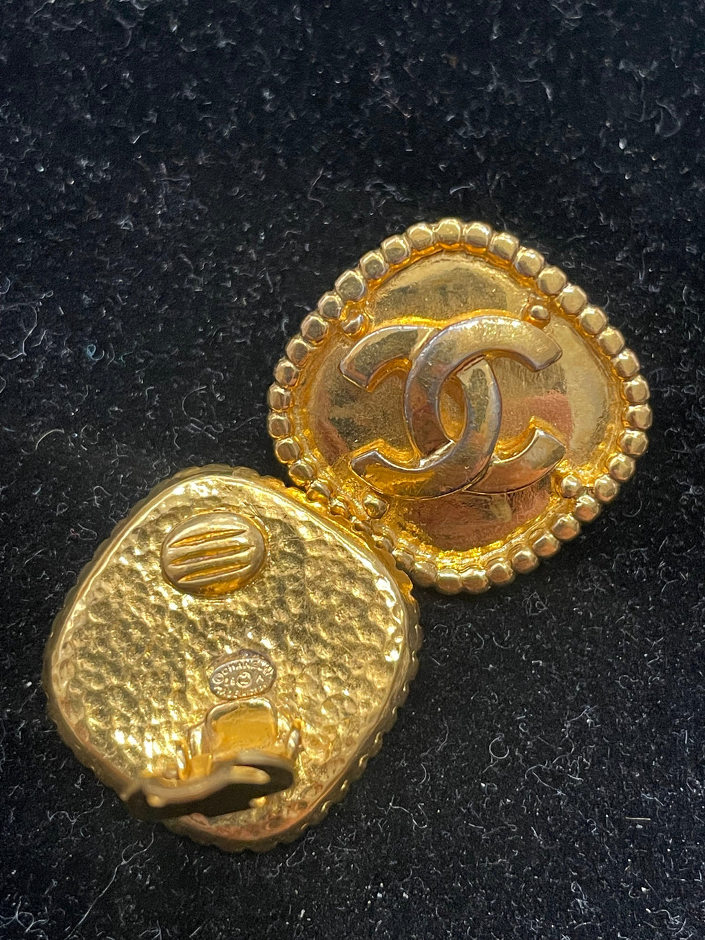 Gold-tone Chanel Rhombus clip-on earrings featuring geometric diamond-shaped design on a plain background.