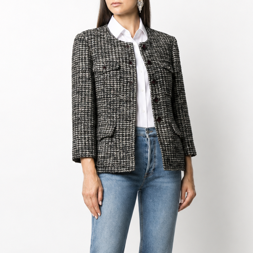 Navy bouclé tweed jacket by Chanel, tailored blazer with textured fabric and classic design, displayed on a hanger.