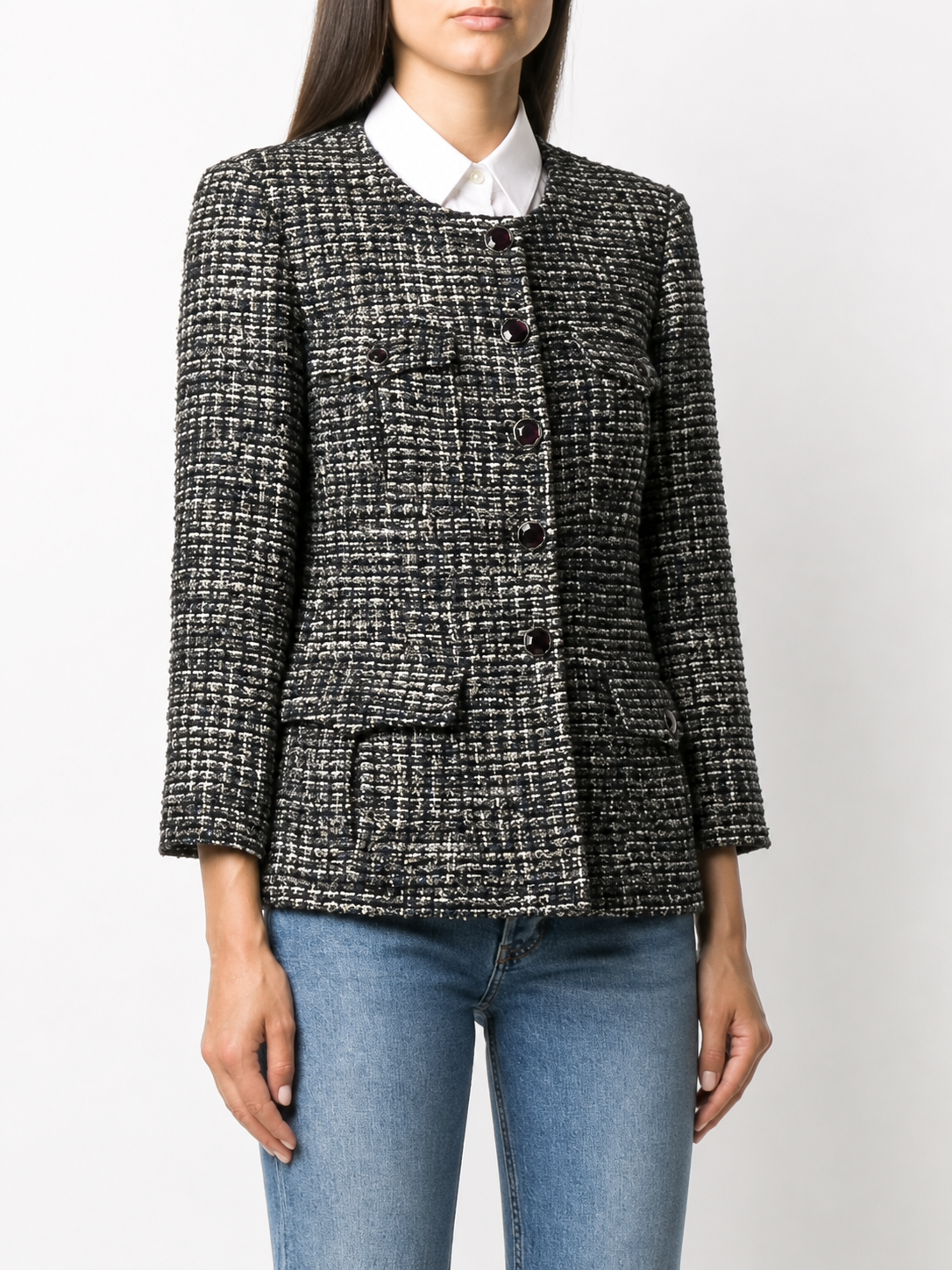 Navy bouclé tweed Chanel blazer with classic tailored fit and textured fabric, featuring a structured collar and button details.