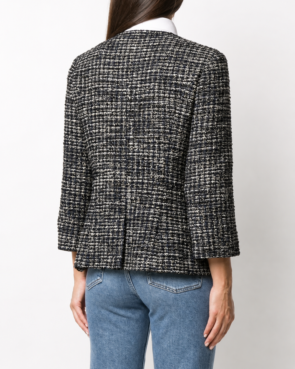 Navy bouclé tweed blazer by Chanel featuring classic textured fabric and tailored fit with notch lapels and front pockets.