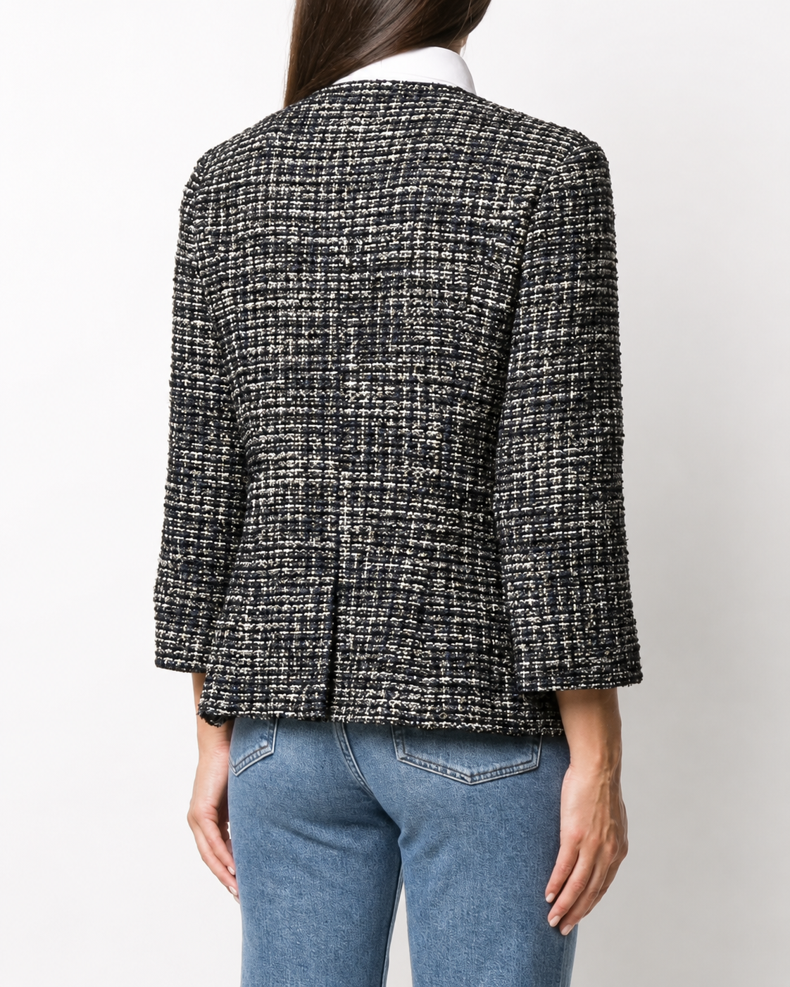 Navy bouclé tweed blazer by Chanel featuring classic textured fabric and tailored fit with notch lapels and front pockets.