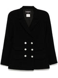 Navy double-breasted Chanel blazer with structured lapels and tailored fit, showcasing classic elegance and high-quality fabric.