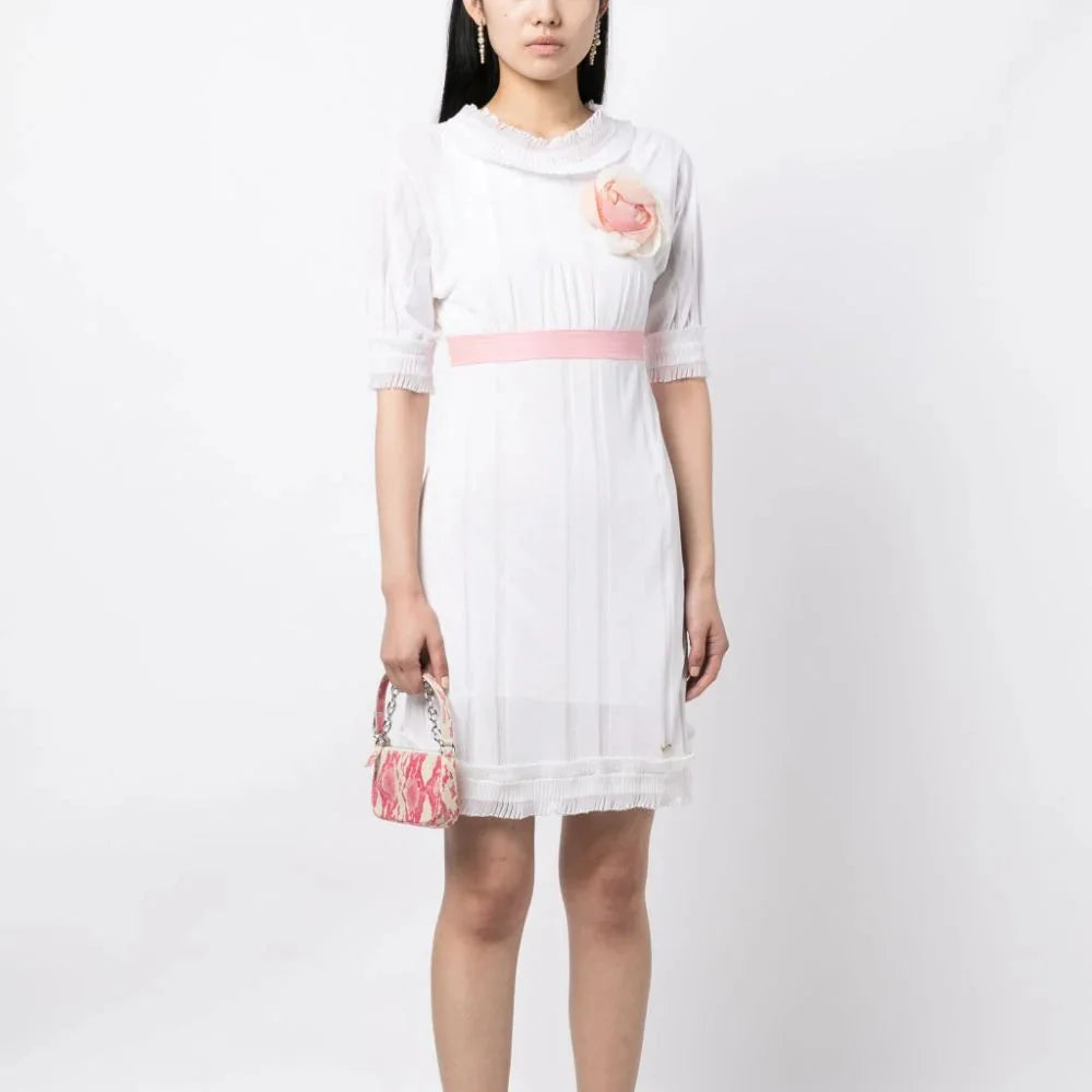 White Chanel Camelia Babydoll Dress, elegant sleeveless dress with delicate fabric and feminine silhouette.