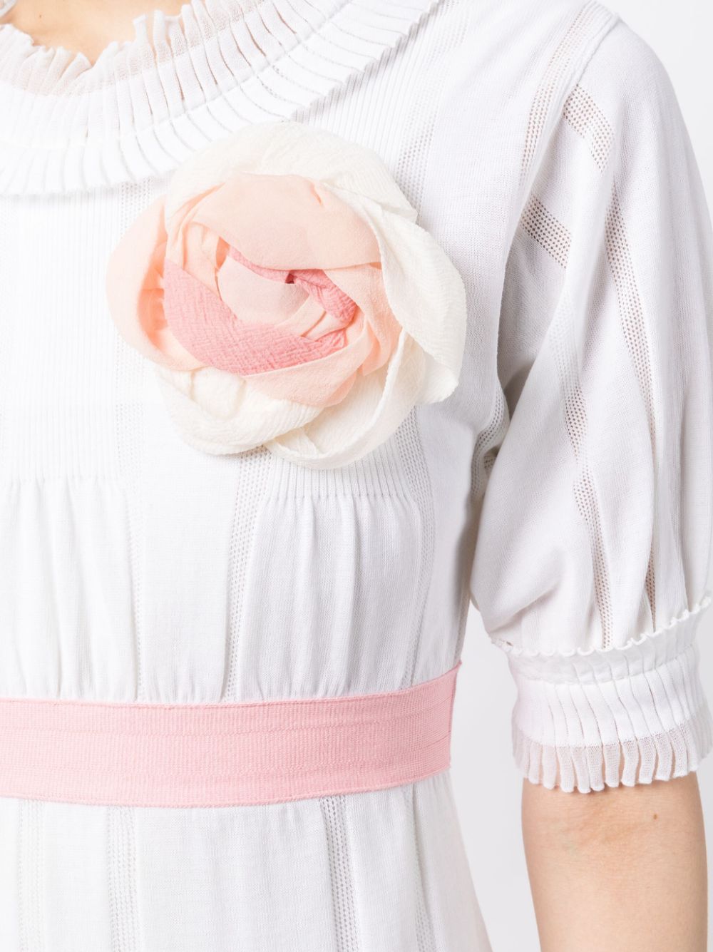 White Chanel Camelia babydoll dress with delicate fabric and flowing silhouette, perfect for elegant, feminine wear.