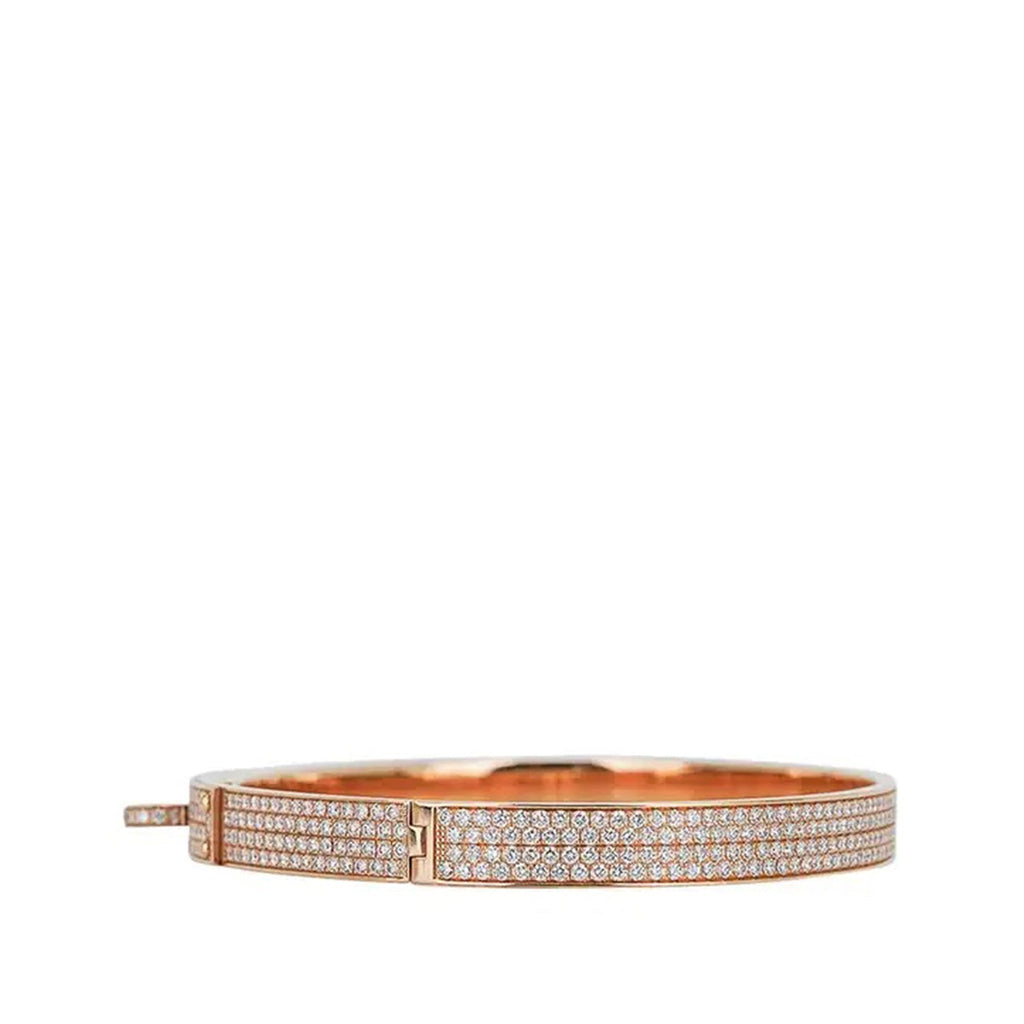 Hermès rose gold diamond Kelly bracelet with intricate design, featuring sparkling diamonds on a sleek, elegant bracelet side view.