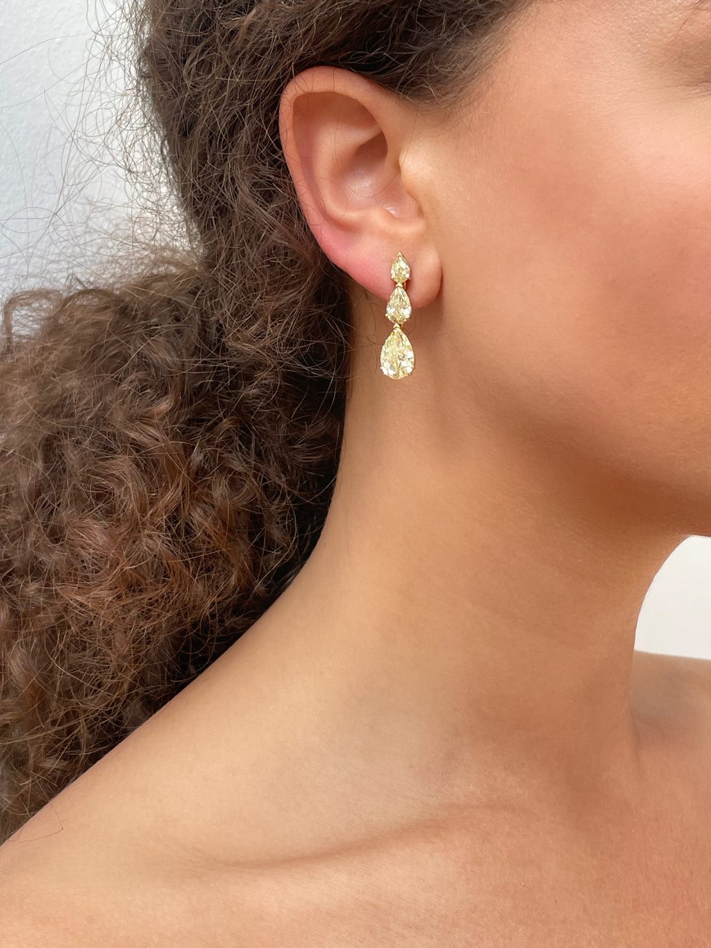 Bucherer fancy yellow diamond earrings featuring sparkling yellow diamonds set in elegant earrings design.