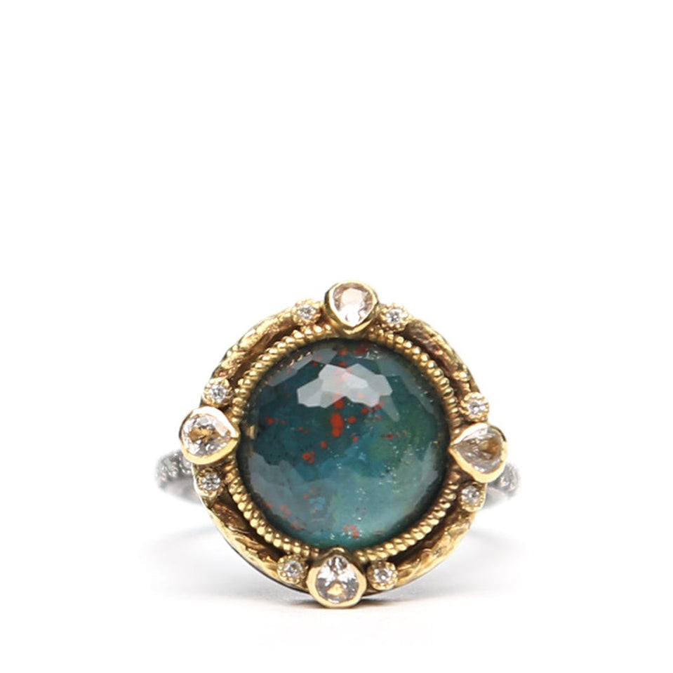 Green oval stone diamond ring by Other Designers showcasing a detailed gold band with a prominent green oval gemstone and sparkling diamonds.
