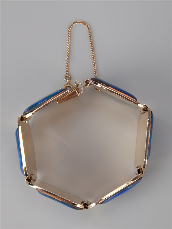 Vintage 1970s bracelet from Vintage Finds featuring intricate metalwork and retro style on a neutral background.