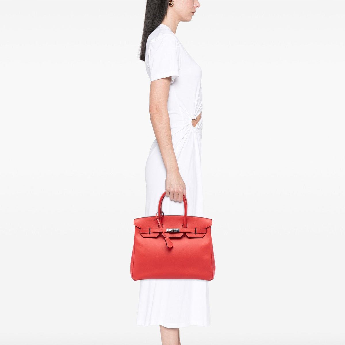 Hermès Birkin 35 Retourne Epsom top handle bag in PHW, showcasing its luxurious beige leather with gold hardware detail.
