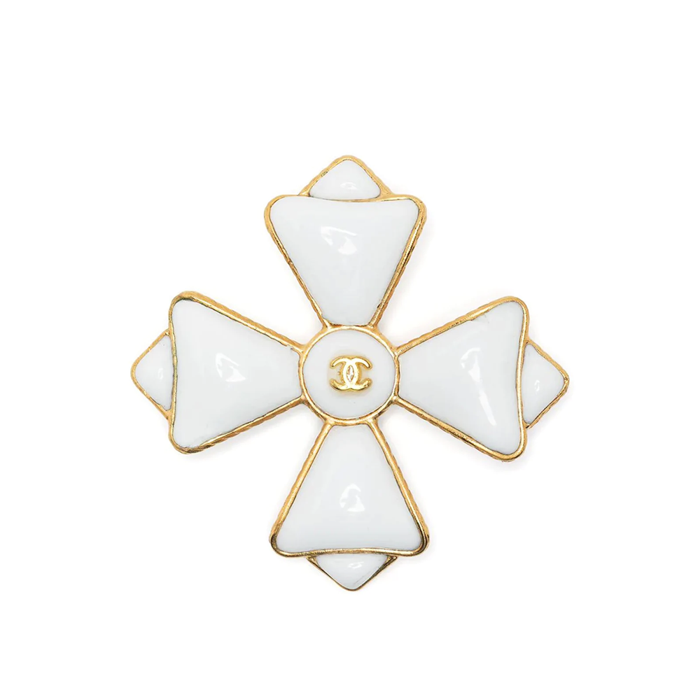 Chanel Maltese Cross brooch featuring a gold-tone cross design with intricate detailing, worn as an elegant accessory.