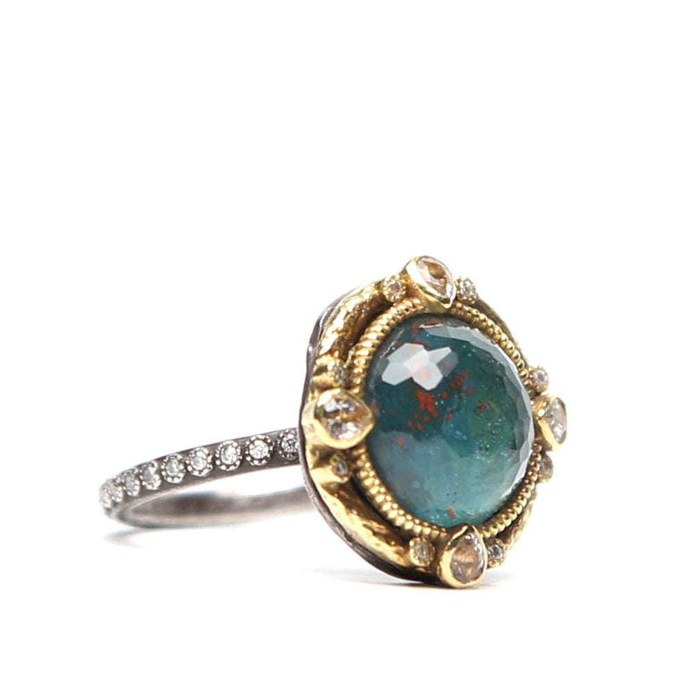 Green oval stone and diamond ring by Other Designers, showcasing a detailed side view of the elegant jewelry piece.