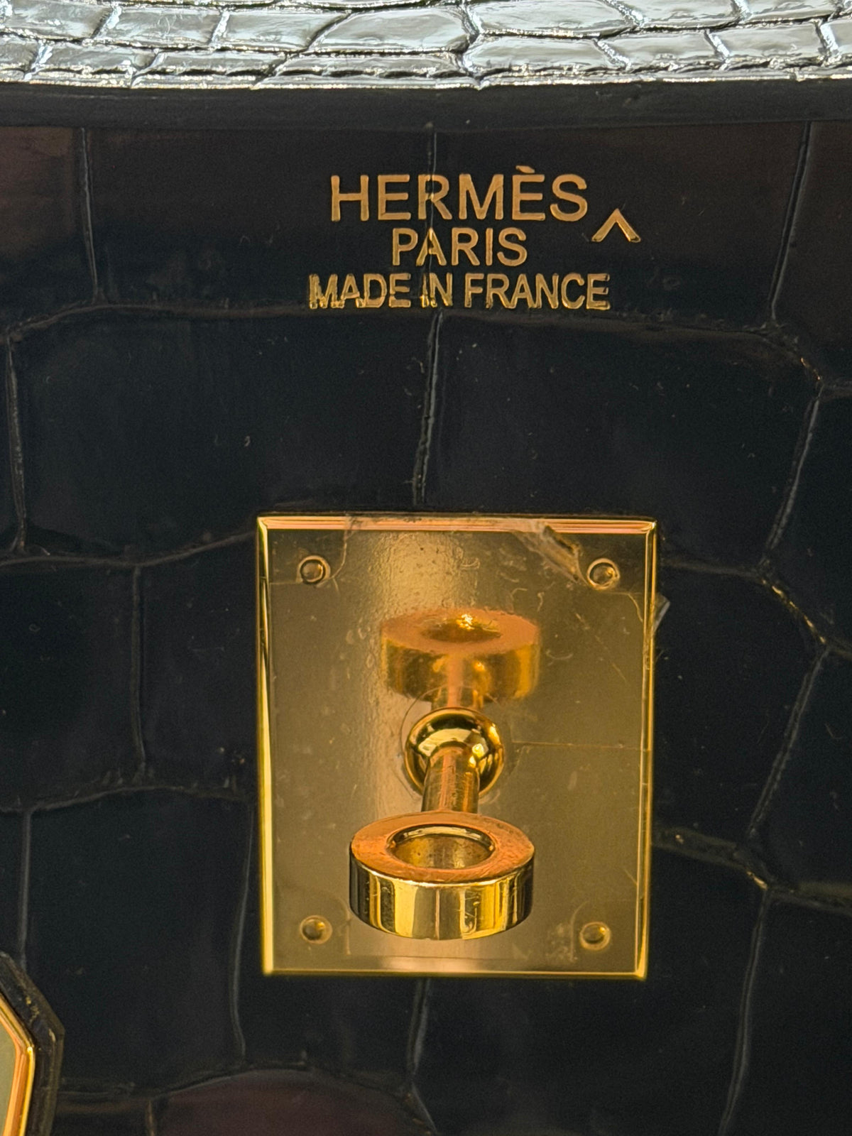 Hermès Birkin 35 black top handle bag with gold hardware, showcasing its luxurious leather finish and elegant design.