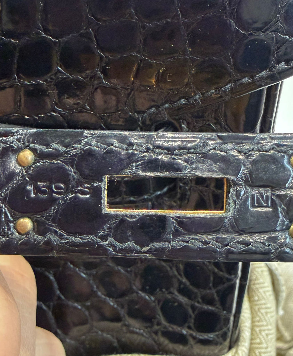 Hermès Birkin 35 black GHW top handle bag with gold hardware, showcasing its luxurious leather and elegant design.