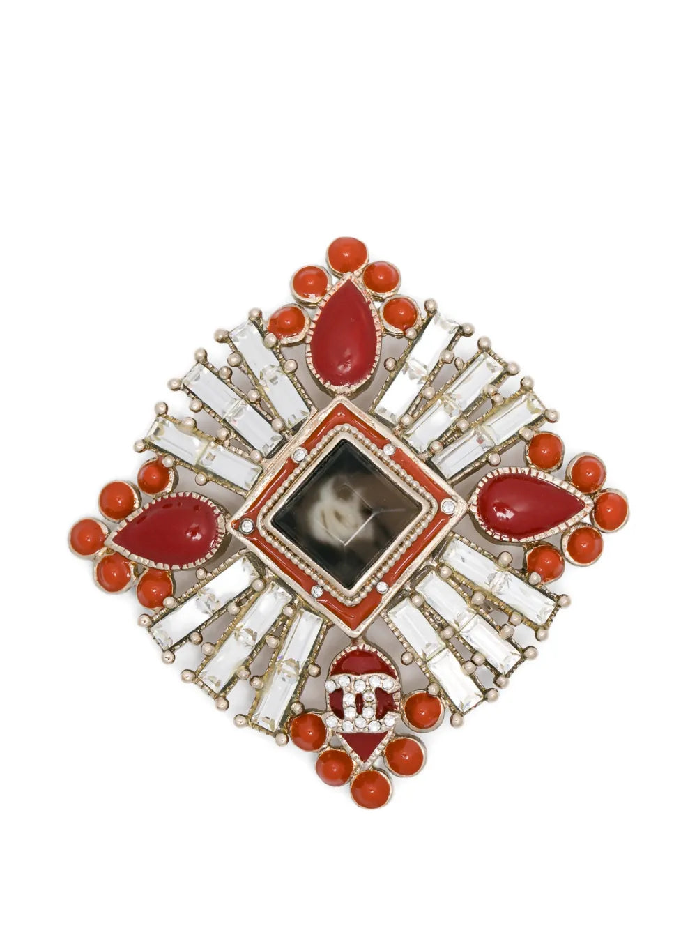 Chanel Crystals and Red Stones CC brooch featuring sparkling crystals and vibrant red stones on a elegant metal setting.