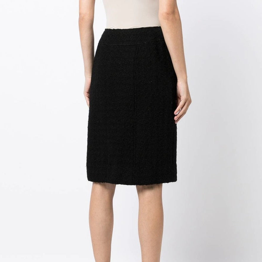 Chanel tweed pencil skirt shown from the back, stylish high-waisted design with classic textured tweed fabric.
