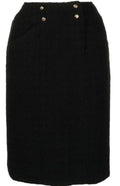 Chanel tweed pencil skirt, tailored high-waisted design with classic checkered pattern and elegant silhouette.