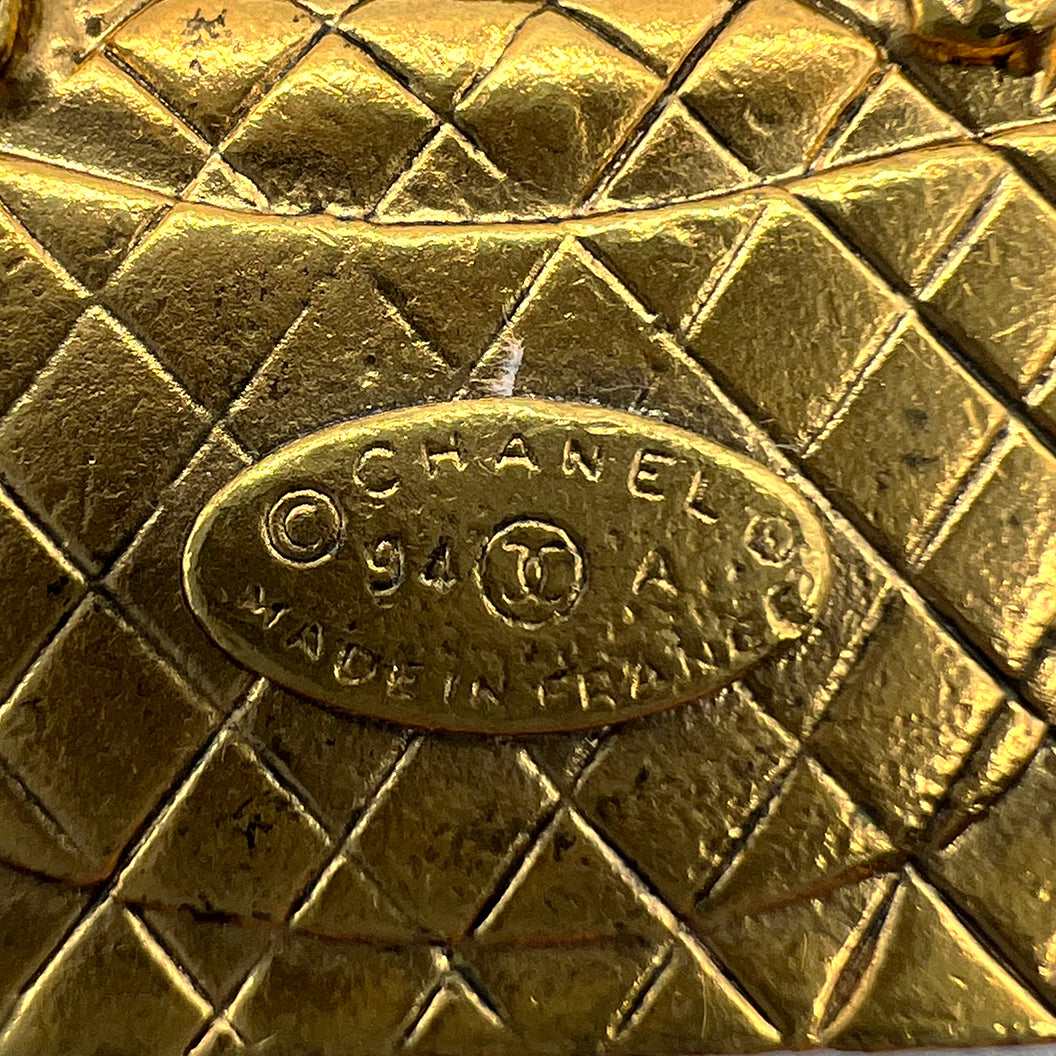 Chanel chain-link bag charm necklace featuring interlocking metal links and signature logo details, elegant accessory for bags.