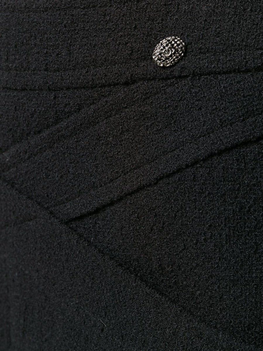 Black wool crisscross skirt by Chanel, showcasing a stylish high-waisted design with intricate overlapping fabric details.