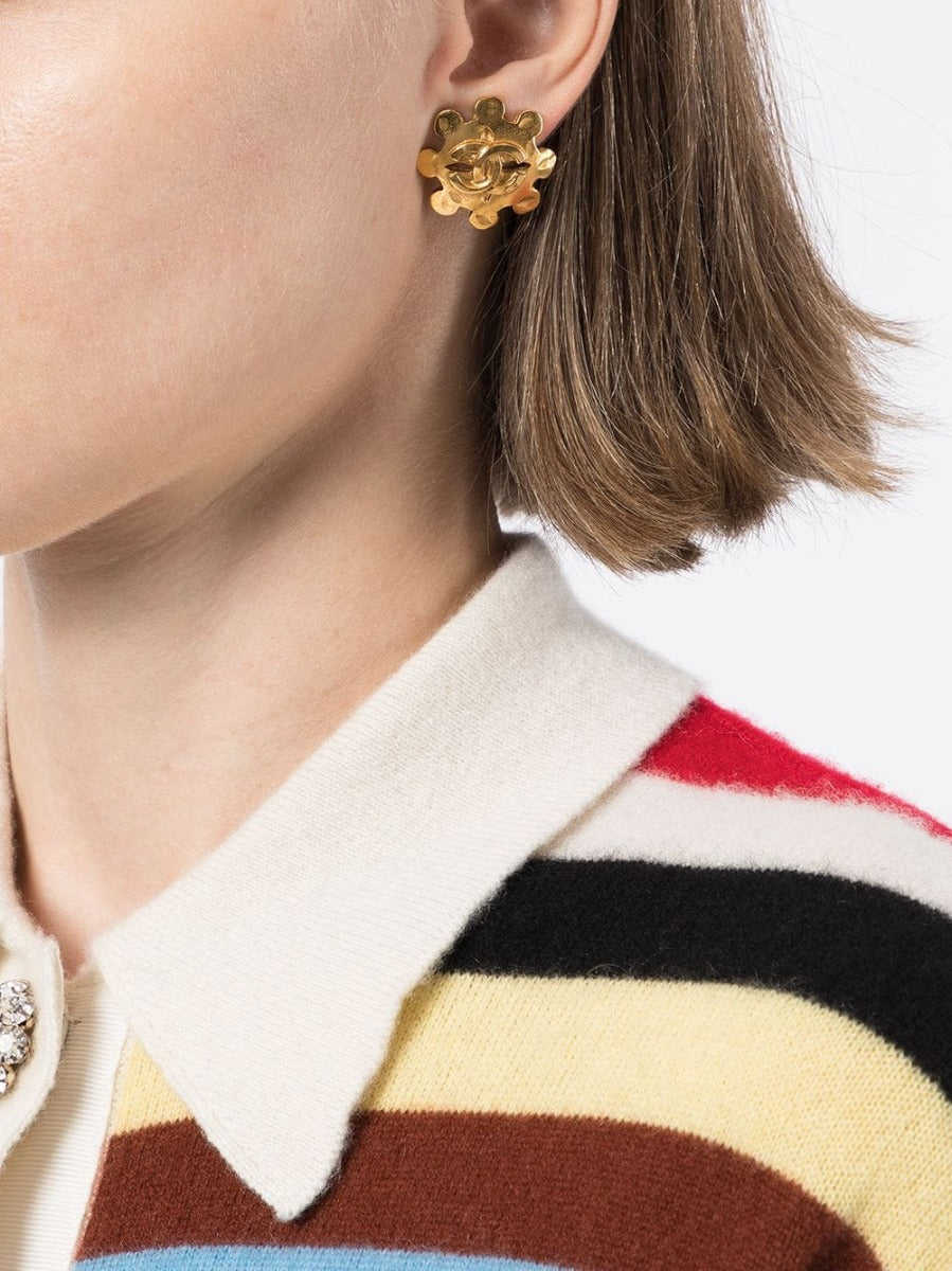 Chanel Cut Out Wheel Clip-On Earrings featuring circular design with silver-tone finish and signature logo detailing.