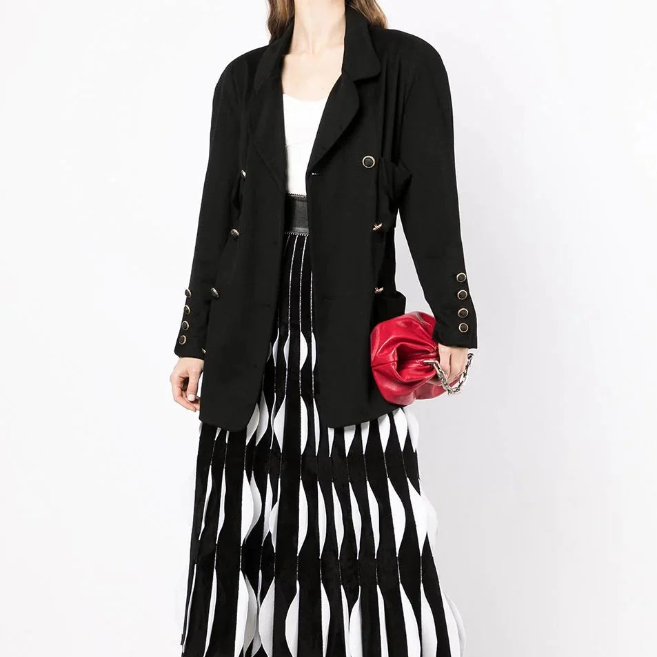 Chanel double-breasted cashmere blazer shown on a hanger, featuring classic design and luxurious fabric.