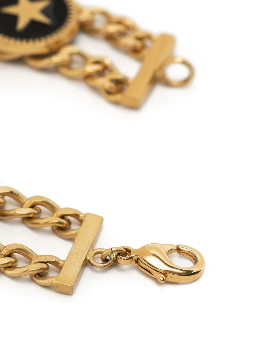 Chanel double chain charm bracelet featuring interlinked gold chains and decorative charms on a white background.