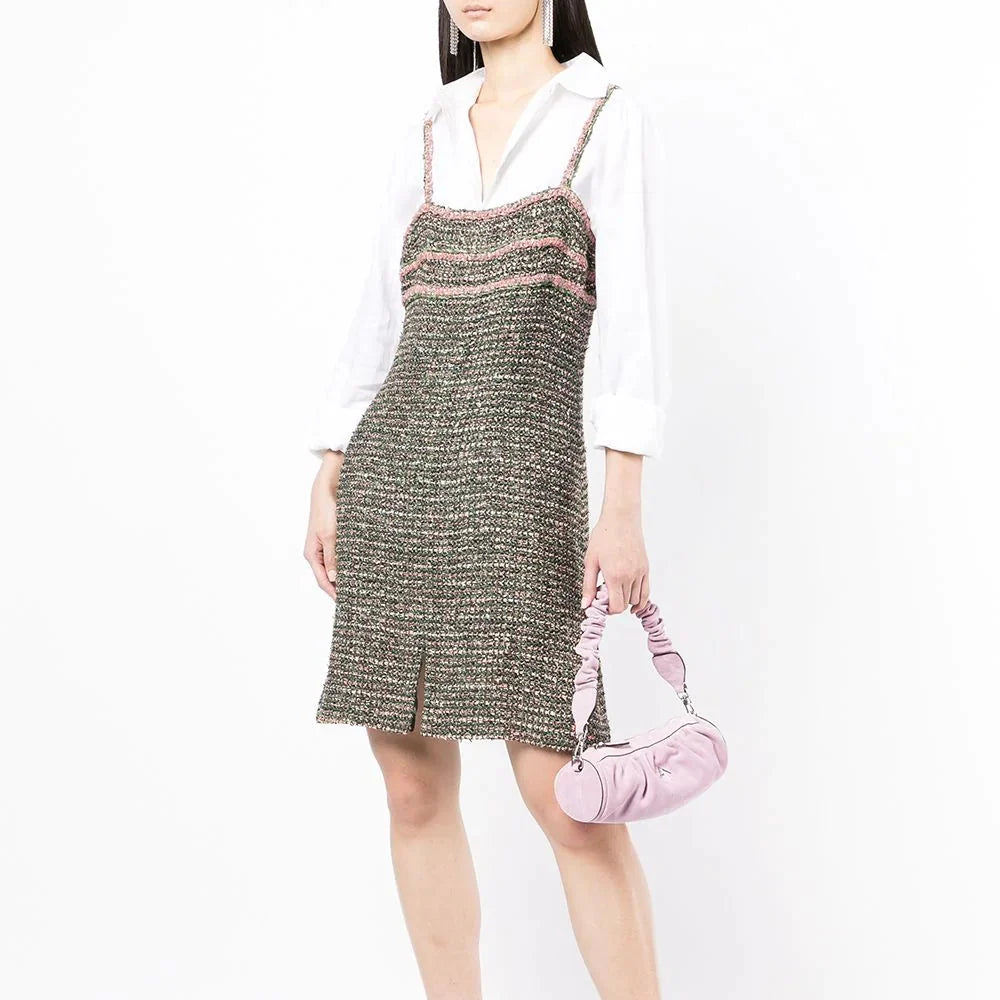 Green Chanel tweed dress with classic tailored design and textured fabric, perfect for elegant occasions.
