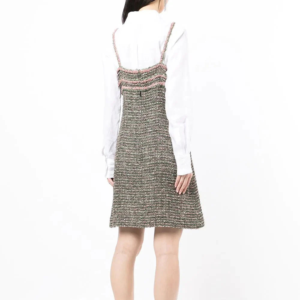 Elegant green tweed dress by Chanel featuring classic tailored design and textured fabric, perfect for sophisticated occasions.