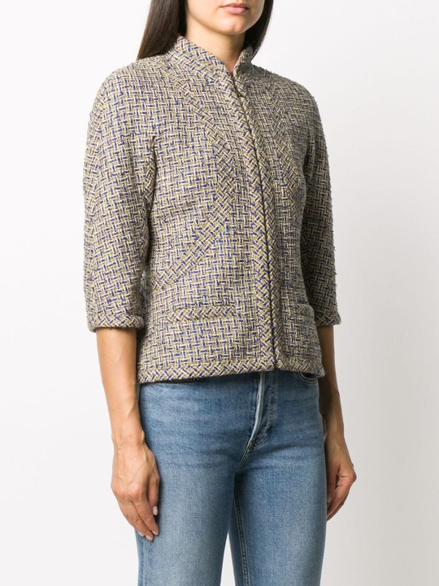 Chanel grey tweed zip jacket, a stylish blazer with a textured tweed fabric and front zipper closure, displayed on a hanger.