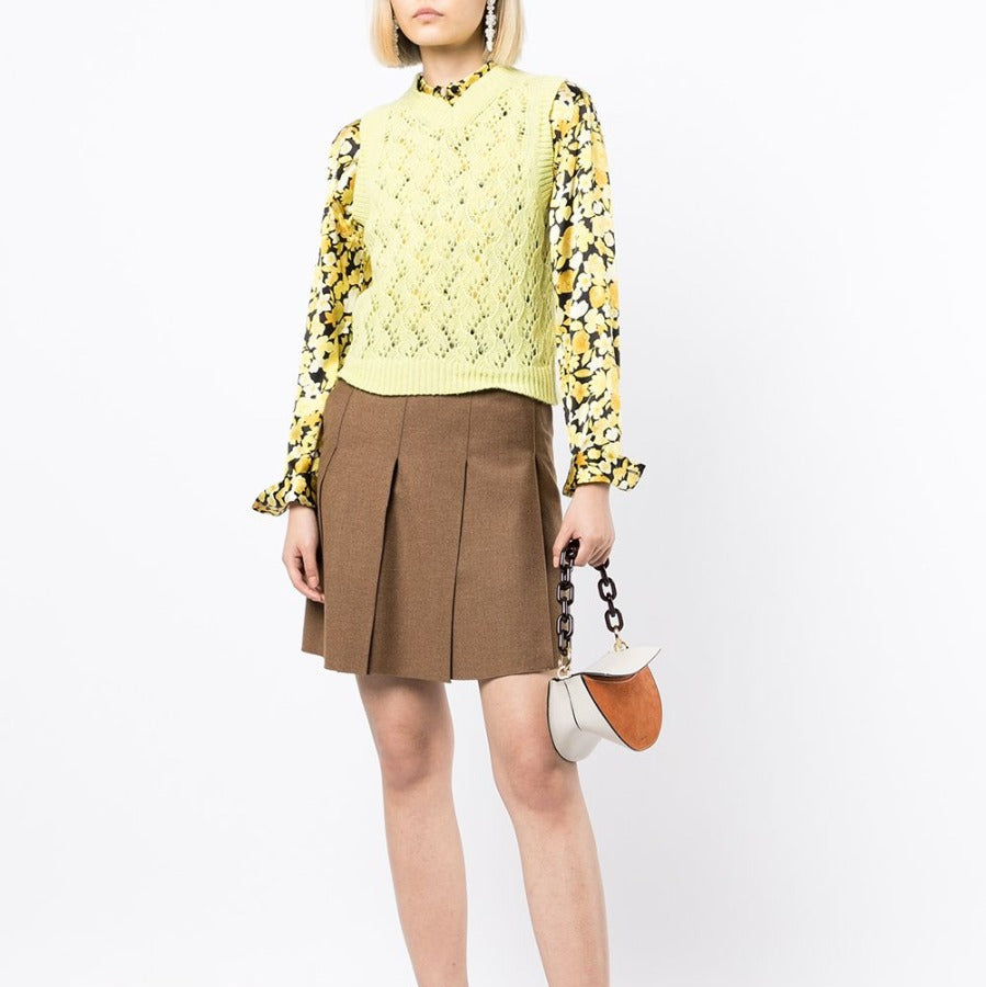 Chanel pleated brown skirt with elegant fabric and classic design, showcased on a neutral background.