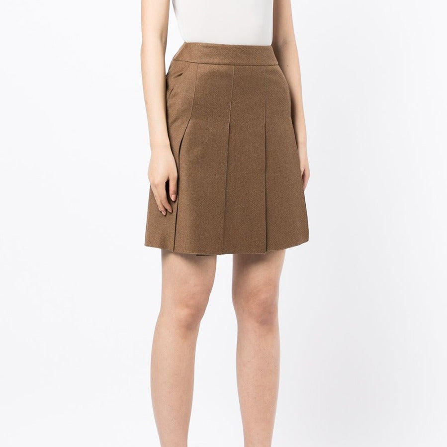 Chanel pleated brown skirt made of fabric with a fitted waist and flowing pleats, displayed on a neutral background.