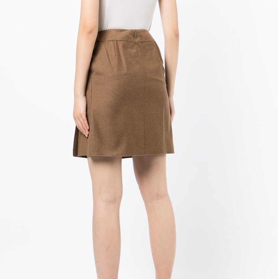 Chanel pleated brown skirt made of flowy fabric, featuring a classic design and elegant pleats, perfect for sophisticated style.