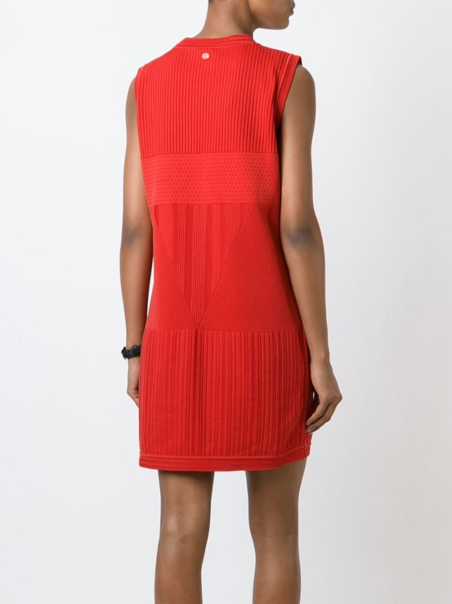 Chanel sleeveless red knit dress displayed on a mannequin, highlighting its stylish design and vibrant color.