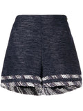 Chanel striped blue tweed shorts with a tailored fit and classic pattern, featuring a high waist and stylish design.