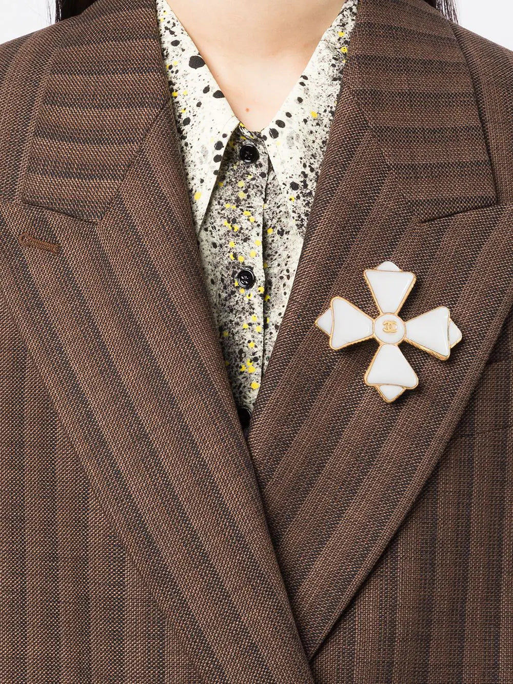 White Chanel Maltese Cross brooch featuring iconic design, detailed craftsmanship, and elegant metallic finish.