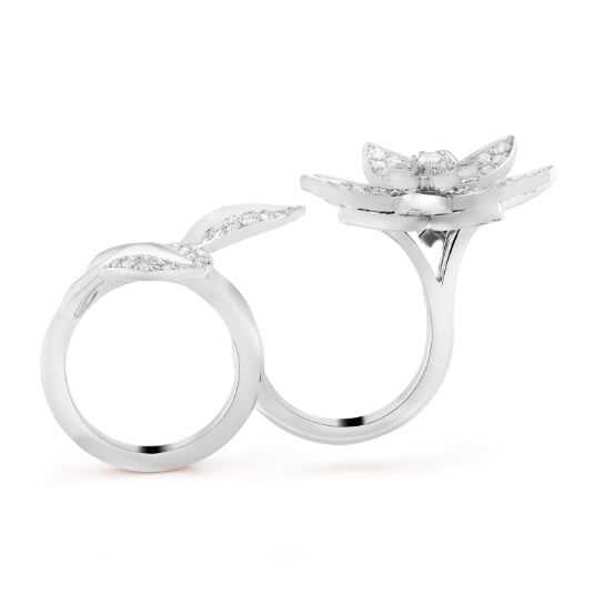 Van Cleef & Arpels diamond lotus between the finger ring featuring intricate design and sparkling diamonds, crafted in precious metal.