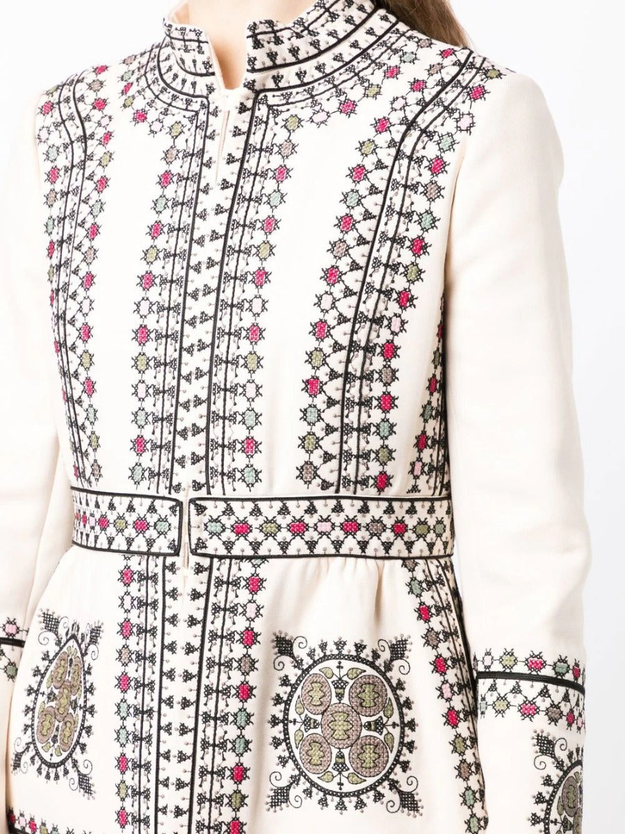 Close-up of an embroidered high-neck coat by Other Designers, showcasing detailed stitching and elegant design.