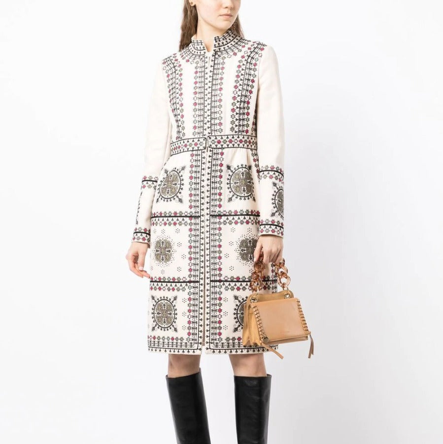 Model wearing an embroidered high-neck coat by Other Designers, showcasing detailed embroidery and stylish high-neck design.
