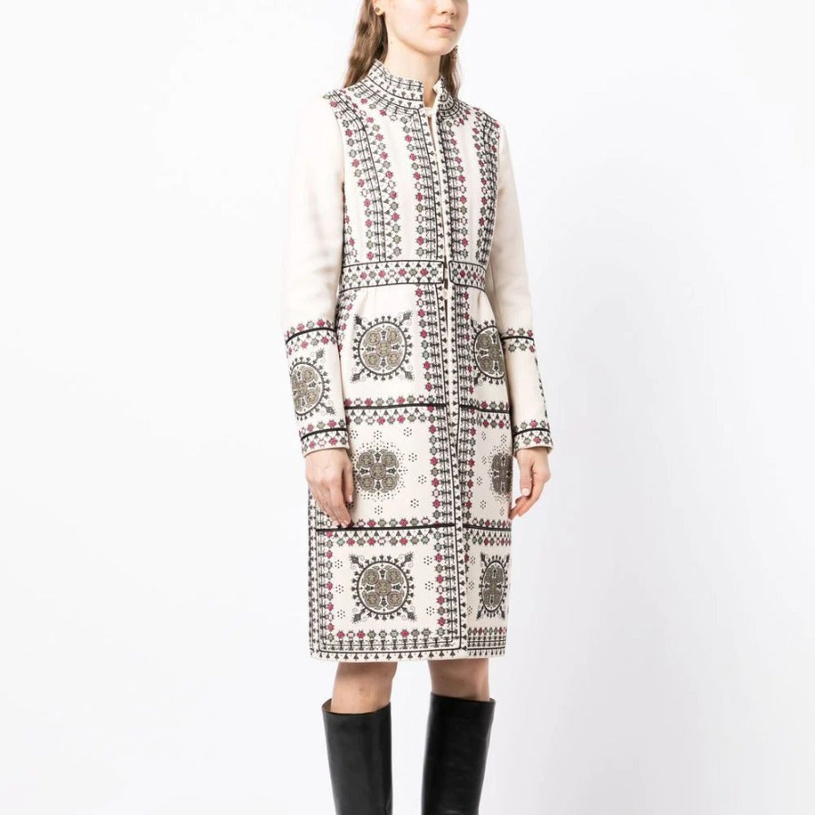 Model wearing an embroidered high-neck coat from Other Designers, showcasing detailed stitching and stylish collar design.