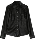 Black elasticated Chanel top with fitted design and long sleeves, showcasing a sleek, modern style.