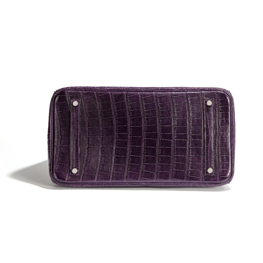 Hermès Birkin 35 Amethyst purple crocodile leather top handle bag with gold hardware, showcasing luxurious craftsmanship.