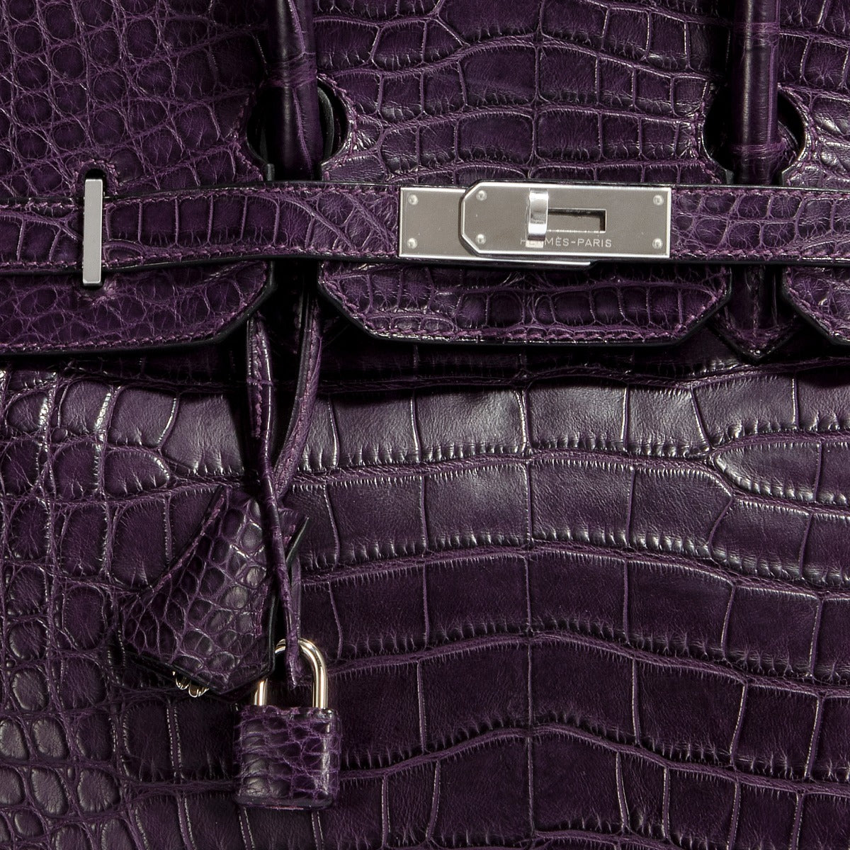Hermès Birkin 35 Amethyst purple crocodile leather top handle bag with gold hardware, showcasing luxurious textured finish.