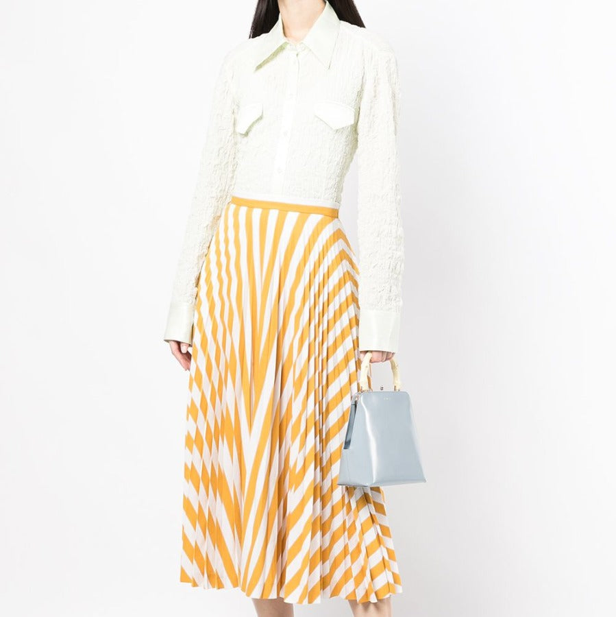 Yellow striped pleated midi skirt from Other Designers, showcasing its flowing fabric and stylish design.