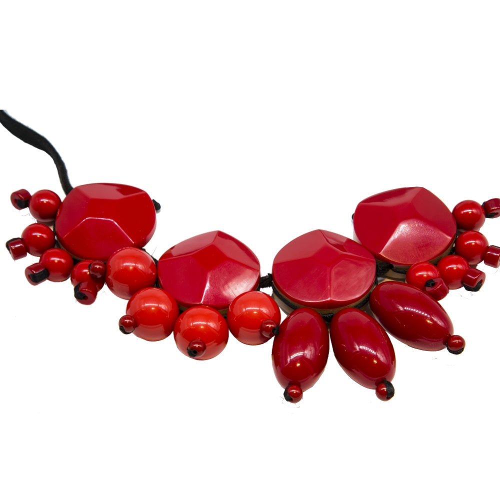 Red acrylic pendant necklace from Other Designers featuring a bold, modern design with a sleek red pendant on a simple chain.