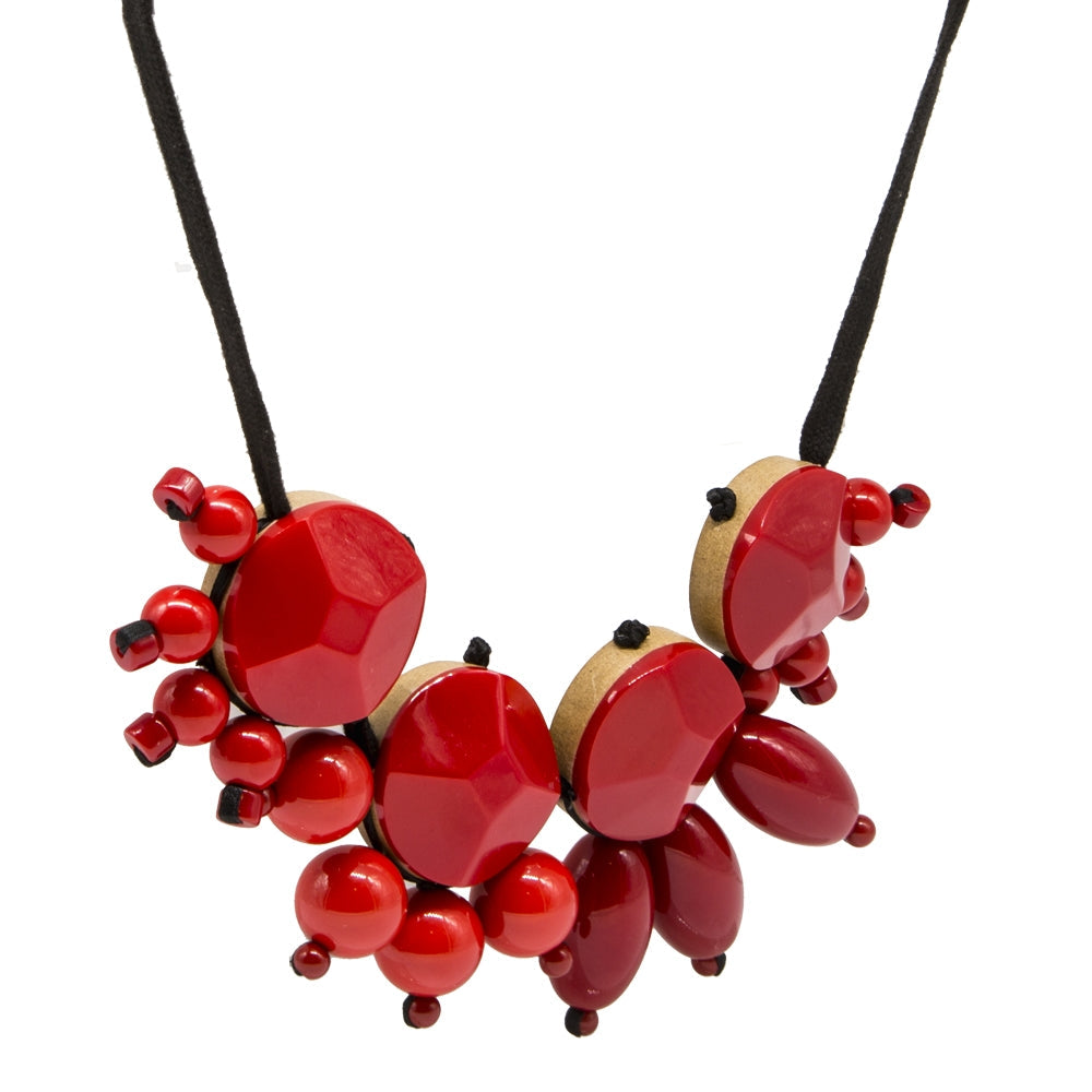 Red acrylic pendant necklace from Other Designers, featuring a layered design, displayed on a neutral background.
