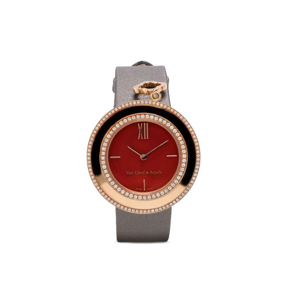 Van Cleef & Arpels rose gold charms watch with a delicate round face and decorative charms hanging from the band.