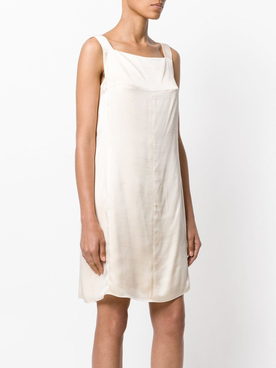 Elegant vintage Chanel peach silk-satin dress with classic design and flowing fabric, perfect for sophisticated occasions.